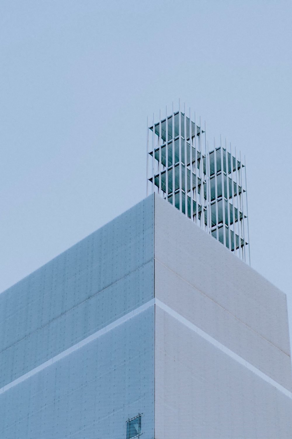 Angular white building volume standing against a clear blue sky