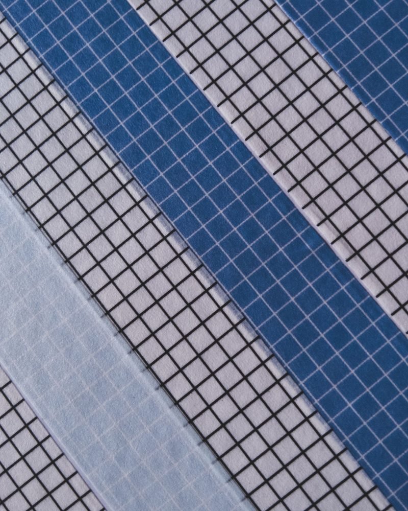 Blue-tinted glass office facade seen at a sharp angle