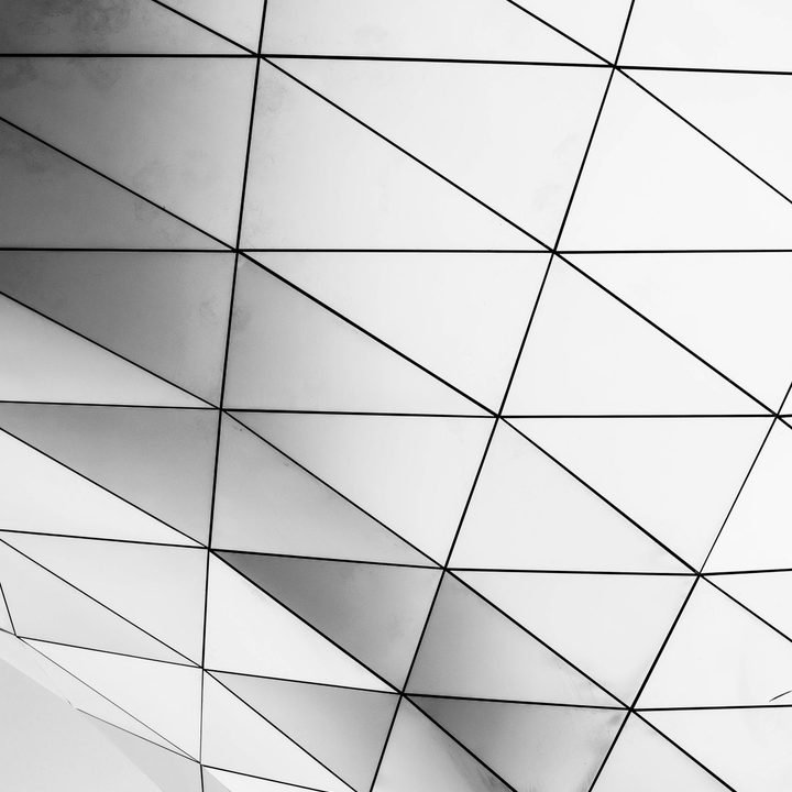 Folded white triangulated panel structure seen from below